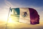 A MEXICAN FLAG FLIES IN A RISING SUN