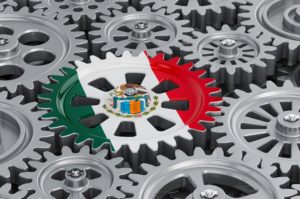 MANY COGS INTERACT TOGETHER, ONE PAINTED WITH THE FLAG OF MEXICOStock-natatravel-1261506189.jpg