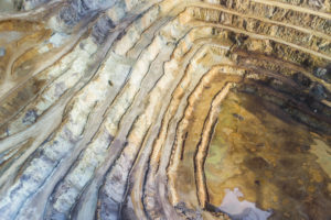 A LOOKING-DOWN VIEW OF AN OPEN PIT RARE EARTH ELEMENTS MINE