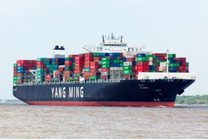 A GIANT CONTAINER VESSEL SPORTING THE LETTERING OF YANG MING PLIES THE SEAS